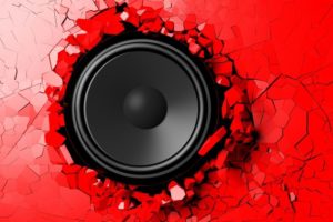 Red_wall_breaks_from_the_sound_of_a_loudspeaker._3d_illustration