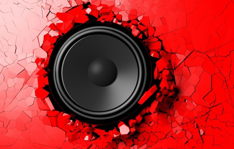 Red_wall_breaks_from_the_sound_of_a_loudspeaker._3d_illustration
