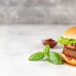 Vegan_burger_on_white_rustic_background._Copy_space._Banner