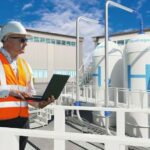Hydrogen_power_factory._Man_with_laptop._Electrolysis_of_hydrogen._H2_tanks_near_factory._Guy_controls_H2_electrolysis._Man_maintains_hydrogen_power_plant._Sustainability,_renewability,_eco