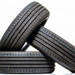 Stack_of_brand_new_high_performance_car_tires_on_clean_high-key_white_studio_background