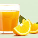 Glass_of_fresh_orange_juice_isolate_on_white_background,_Fresh_fruits_Orange_juice_in_glass_with_group_of_orange_on_white__background,_Selective_focus_on_glass.