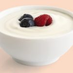 Ceramic_bowl_of_white_yoghurt_with_berries_isolated_on_white_background.