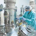 Pharmaceutical_technician_in_sterile_environment_at_pharmacy_industry